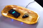 Phones Charging Wirelessly in Wood Bowl